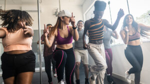 Young people in a fitness class dancing to music